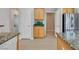 Close up of kitchen featuring granite counters and stainless steel refrigerator at 2292 Saxtons River Rd, Henderson, NV 89044