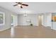 Spacious living room with tile flooring, sliding glass doors to the yard, and updated lighting fixtures at 2292 Saxtons River Rd, Henderson, NV 89044