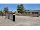 Expansive front yard with mature trees, concrete block fence and a glimpse of a neighboring house at 2315 Lincoln Rd, Las Vegas, NV 89115