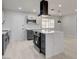 Contemporary kitchen features a large kitchen island, modern hood, white cabinets and modern fixtures at 2315 Lincoln Rd, Las Vegas, NV 89115