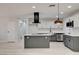 Open-concept kitchen featuring stainless appliances, a kitchen island, and modern white cabinets at 2315 Lincoln Rd, Las Vegas, NV 89115