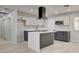 Contemporary kitchen with white cabinets, marble counters, a kitchen island, and modern stainless appliances at 2315 Lincoln Rd, Las Vegas, NV 89115