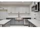Modern kitchen with gray cabinets, stainless steel appliances, white countertops, and a sink at 2315 Lincoln Rd, Las Vegas, NV 89115