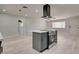 Bright open concept kitchen featuring a kitchen island, modern lighting, stainless appliances, and a door at 2315 Lincoln Rd, Las Vegas, NV 89115