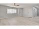 Bright living room with light colored flooring and walls, a ceiling fan, and large window at 2315 Lincoln Rd, Las Vegas, NV 89115