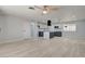 Open-concept living space featuring new floors, modern light fixtures, and an adjacent kitchen at 2315 Lincoln Rd, Las Vegas, NV 89115