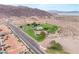 Wide aerial shot of community amenities featuring playground, tennis courts, and nearby mountains at 251 Big Horn Dr, Boulder City, NV 89005