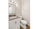 Compact bathroom with a single sink vanity, toilet, and wood-look flooring at 251 Big Horn Dr, Boulder City, NV 89005