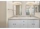 Bright bathroom featuring a double vanity with white cabinets and granite countertops at 251 Big Horn Dr, Boulder City, NV 89005
