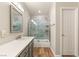 Elegant bathroom featuring updated vanity and marble-tiled walk-in shower at 251 Big Horn Dr, Boulder City, NV 89005