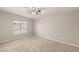 Bright bedroom featuring plush carpeting, a ceiling fan, and a sunlit window at 251 Big Horn Dr, Boulder City, NV 89005