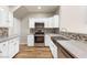 Bright kitchen featuring white cabinets, wood floors, and stainless steel appliances at 251 Big Horn Dr, Boulder City, NV 89005
