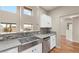 Kitchen showcasing a stainless steel sink and tiled backsplash with abundant natural light at 251 Big Horn Dr, Boulder City, NV 89005