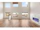 Bright living room with high ceilings, modern fireplace, and multiple large windows at 251 Big Horn Dr, Boulder City, NV 89005