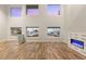 Bright living room featuring wood floors, modern fireplace, and large windows with mountain views at 251 Big Horn Dr, Boulder City, NV 89005