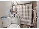 Cozy bathroom with a toilet, vanity with sink, mirror, and shower with curtain at 2528 Sunrise Ave, Las Vegas, NV 89101
