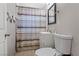 Bright bathroom featuring a toilet, vanity with sink, mirror, and shower with curtain at 2528 Sunrise Ave, Las Vegas, NV 89101