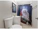Cozy bathroom with a single sink vanity, toilet, and a shower with festive curtain at 2528 Sunrise Ave, Las Vegas, NV 89101