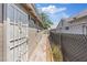 Sideways view of a single-story house with chain link fencing at 2528 Sunrise Ave, Las Vegas, NV 89101