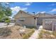 View of the rear of a single-story house with chain link fencing, and some landscaping, including a chair at 2528 Sunrise Ave, Las Vegas, NV 89101
