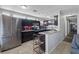 Spacious kitchen with granite countertops, tile flooring, and stainless steel refrigerator at 2528 Sunrise Ave, Las Vegas, NV 89101