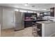 Kitchen features stainless steel refrigerator, black cabinets, and granite counters at 2528 Sunrise Ave, Las Vegas, NV 89101