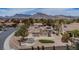 Inviting backyard with desert landscape, covered patio, privacy wall, and mountain views at 2532 Big Timber Dr, Las Vegas, NV 89134