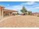Spacious desert backyard with a covered patio, perfect for outdoor entertaining and relaxation at 2532 Big Timber Dr, Las Vegas, NV 89134