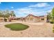 Desert home boasts backyard with patio, grill, and an island of vibrant green artificial turf at 2532 Big Timber Dr, Las Vegas, NV 89134