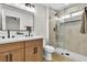 Bathroom with double sinks, modern glass-enclosed shower, updated fixtures, and wood cabinets at 2532 Big Timber Dr, Las Vegas, NV 89134