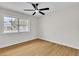 Bedroom with wood flooring, natural light from window, and modern ceiling fan at 2532 Big Timber Dr, Las Vegas, NV 89134