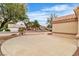 Beige stucco home with a tile roof and expansive driveway, showcasing desert landscaping at 2532 Big Timber Dr, Las Vegas, NV 89134