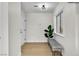 Bright hallway featuring a decorative bench, updated flooring, and modern fixtures at 2532 Big Timber Dr, Las Vegas, NV 89134