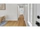 Bright hallway with wood flooring, leading to a bathroom and other rooms with natural light at 2532 Big Timber Dr, Las Vegas, NV 89134