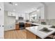 Updated kitchen with white cabinets, stainless steel appliances, quartz countertops, and tile backsplash at 2532 Big Timber Dr, Las Vegas, NV 89134