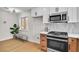 Bright kitchenette with stainless steel appliances, bench seating area, and modern decor at 2532 Big Timber Dr, Las Vegas, NV 89134