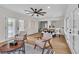Open-concept living area featuring natural light, wood flooring, modern ceiling fan, and adjacent dining area at 2532 Big Timber Dr, Las Vegas, NV 89134