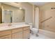 Well-lit bathroom features a single sink vanity, large mirror, and tiled shower-tub combination with grab bar for safety at 2851 S Valley View Blvd # 1039, Las Vegas, NV 89102
