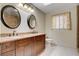 Bright bathroom featuring a tiled floor, dual vanity, and an enclosed glass shower at 2851 S Valley View Blvd # 1039, Las Vegas, NV 89102