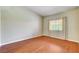 Spacious bedroom with wood floors, a large window, and neutral wall color at 2851 S Valley View Blvd # 1039, Las Vegas, NV 89102