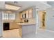Functional kitchen with breakfast bar, tile flooring, and stainless steel microwave at 2851 S Valley View Blvd # 1039, Las Vegas, NV 89102