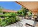 Private patio area, with seating, complemented by lush greenery, and distant community views at 2851 S Valley View Blvd # 1039, Las Vegas, NV 89102