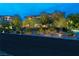 Beautiful front exterior featuring mature trees, manicured landscaping, and a circular driveway at 30 Meadowhawk Ln, Las Vegas, NV 89135