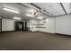 Spacious garage with ample storage cabinets and room for multiple vehicles and featuring a safe room at 30 Meadowhawk Ln, Las Vegas, NV 89135
