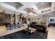 Spacious living room featuring sleek furnishings, stone accent walls and an impressive decorative ceiling design at 30 Meadowhawk Ln, Las Vegas, NV 89135