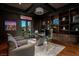 Executive office with custom wood built-ins, glass desk, and outdoor views for a productive workspace at 30 Meadowhawk Ln, Las Vegas, NV 89135