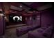 Home theater featuring tiered seating, a large screen, ambient lighting, and comfortable purple seating at 30 Meadowhawk Ln, Las Vegas, NV 89135