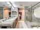 Bathroom with a stand-alone shower, soaking tub, double sinks, and modern finishes at 301 E Longacres Dr, Henderson, NV 89015