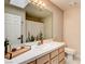 Clean bathroom with a white vanity, a shower with curtain, and a large mirror at 301 E Longacres Dr, Henderson, NV 89015