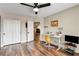Bedroom features hardwood floors, a ceiling fan, walk-in closet, and a study desk at 301 E Longacres Dr, Henderson, NV 89015